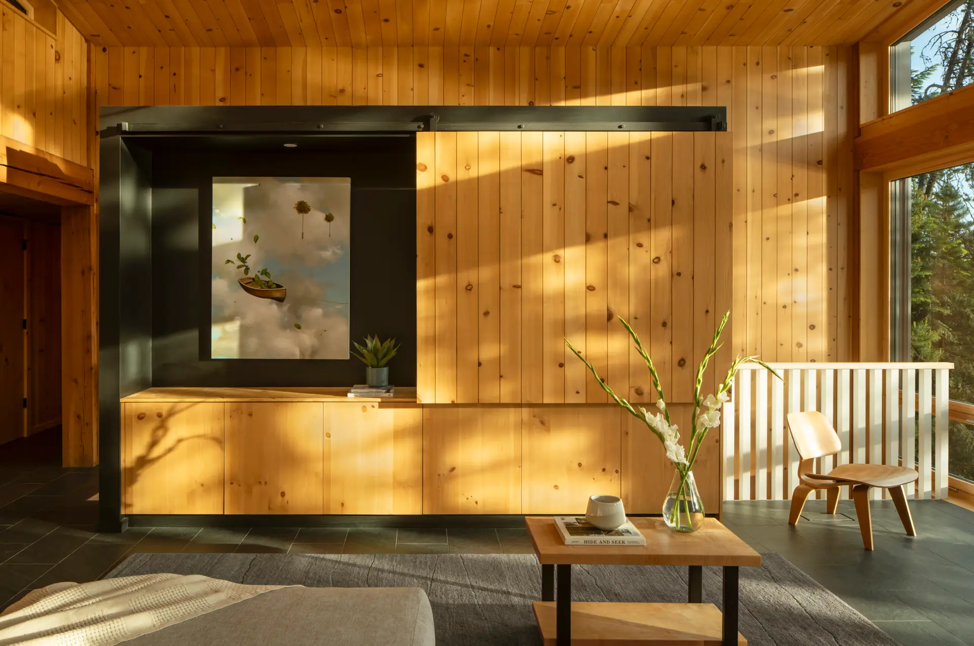 Priest Lake Cabin living room, featuring an operable wood wall that conceals the TV.
