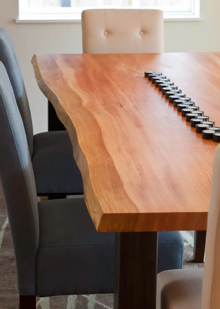A modern dining space featuring a live-edge wood slab table.