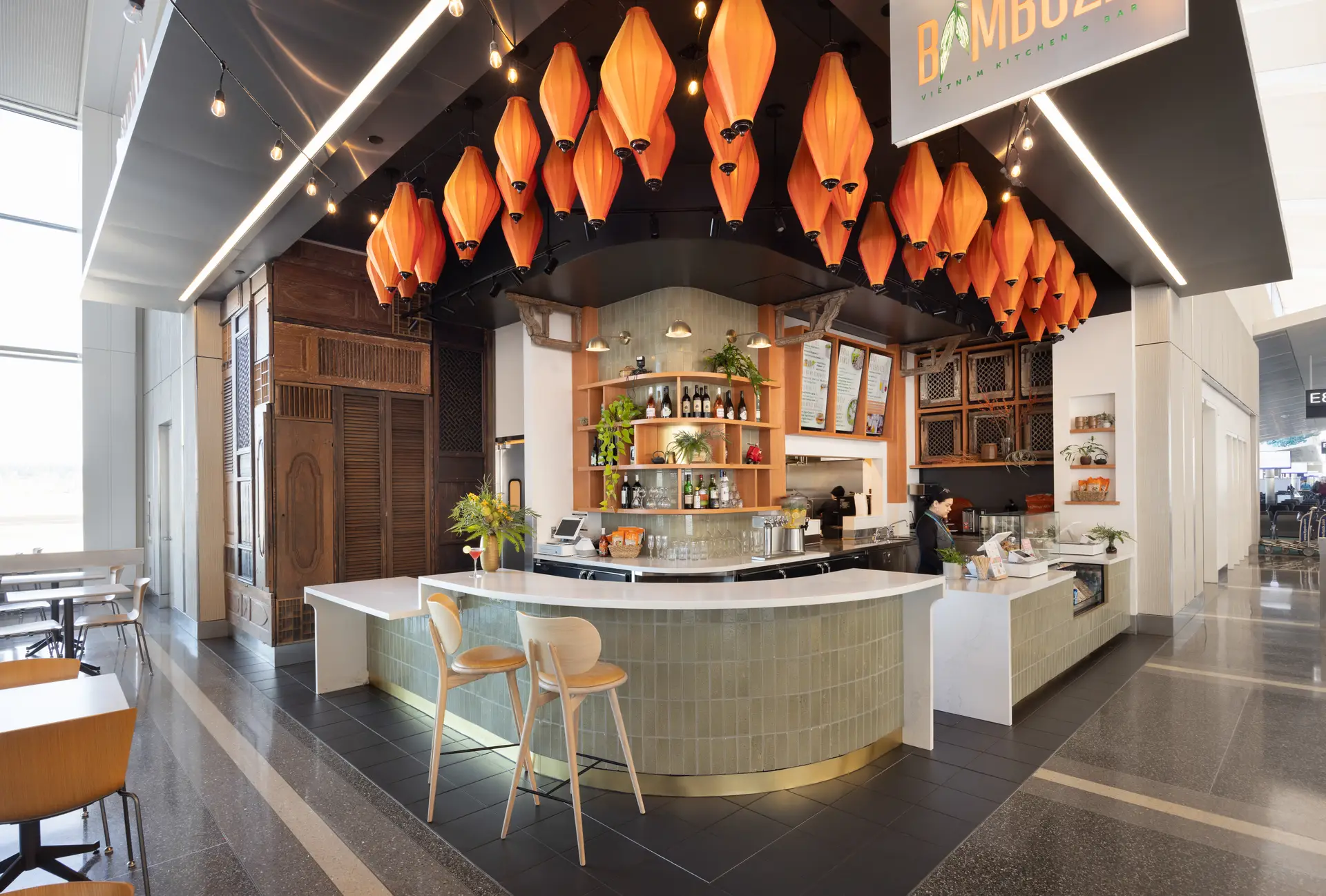 Orange lanterns hanging over the ordering bar at Bambuza.