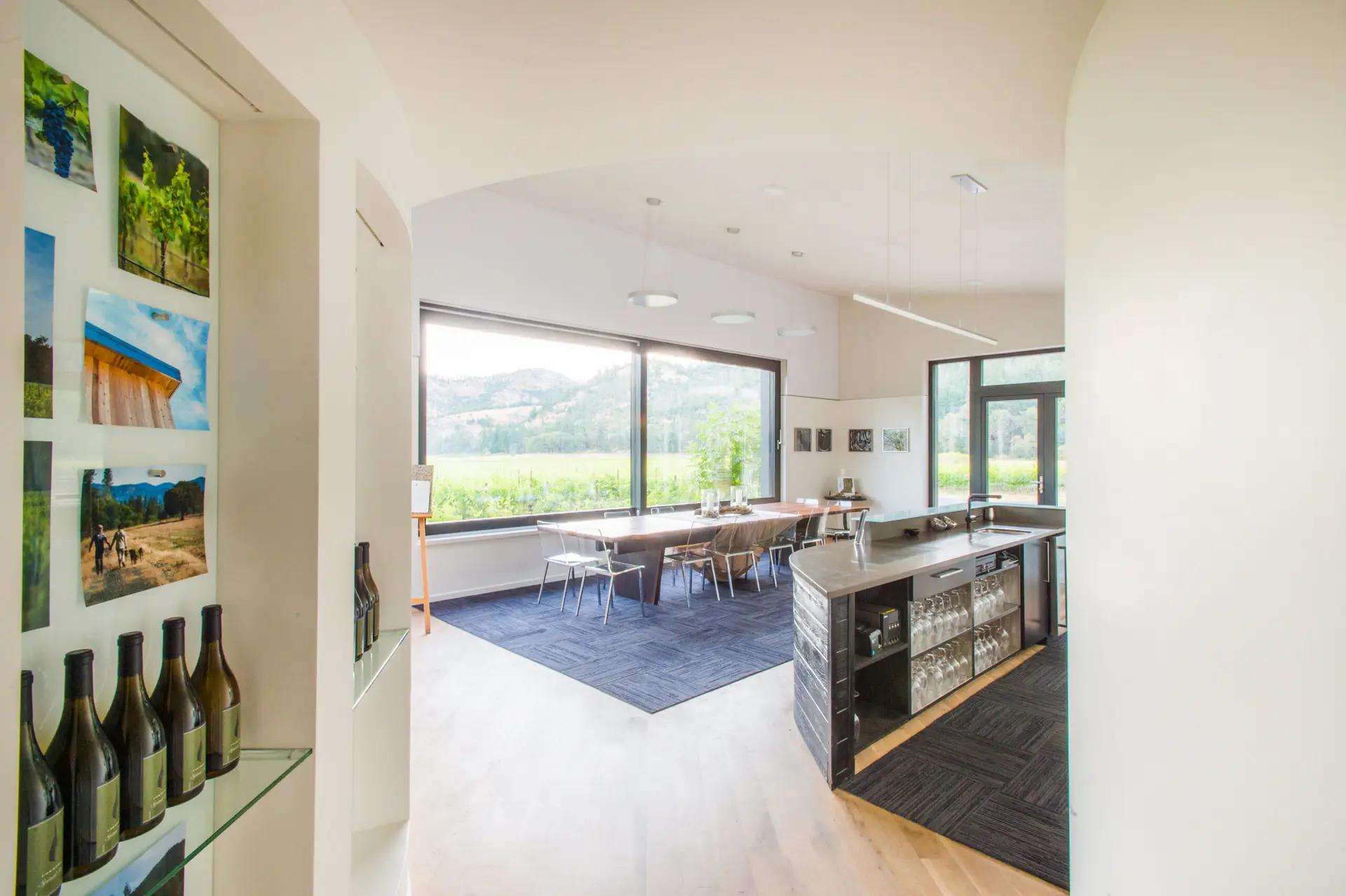 Interior view of with large windows out toward the vinyard. There is a counter and table in the foreground