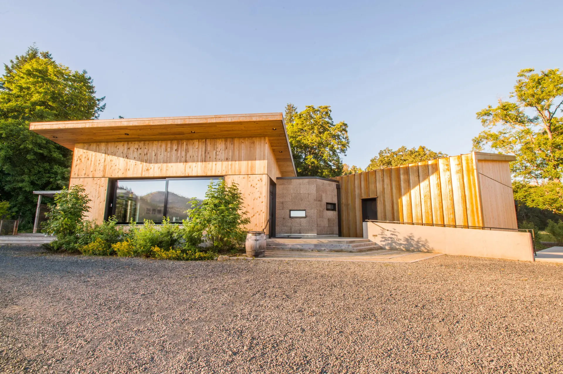 Cowhorn Winery exterior view showing 3 different siding materials: cedar siding, cork siding, and pre-oxidized metal panel