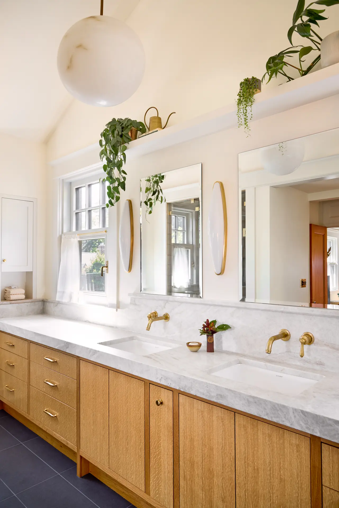 Willamette Heights House Primary Bathroom, featuring light and bright walls, warm wood double vanity, and marble countertop