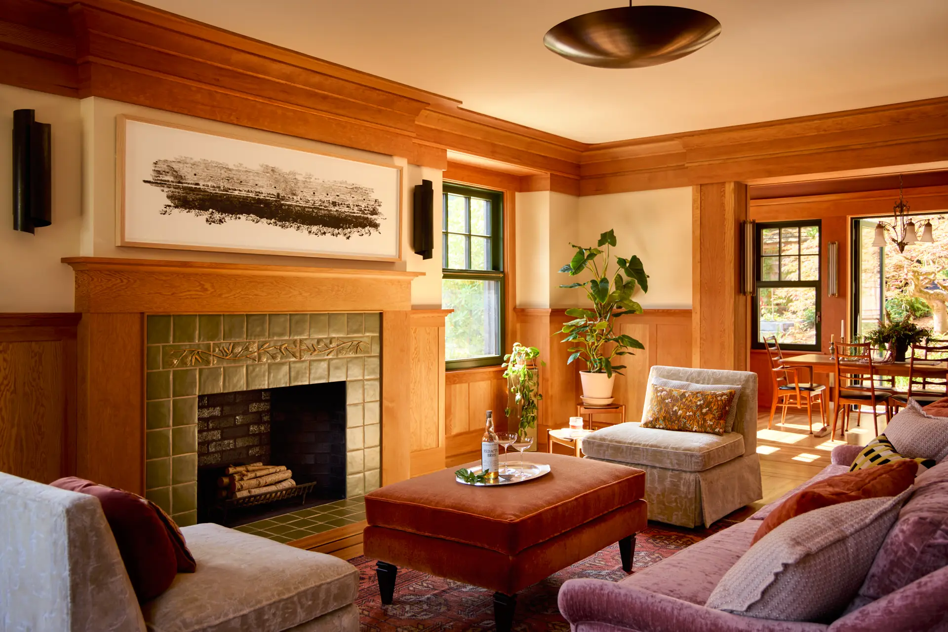 Willamette Heights House living room, featuring wood paneling, a tile surround fireplace, and ornate wood molding along the top of wall.