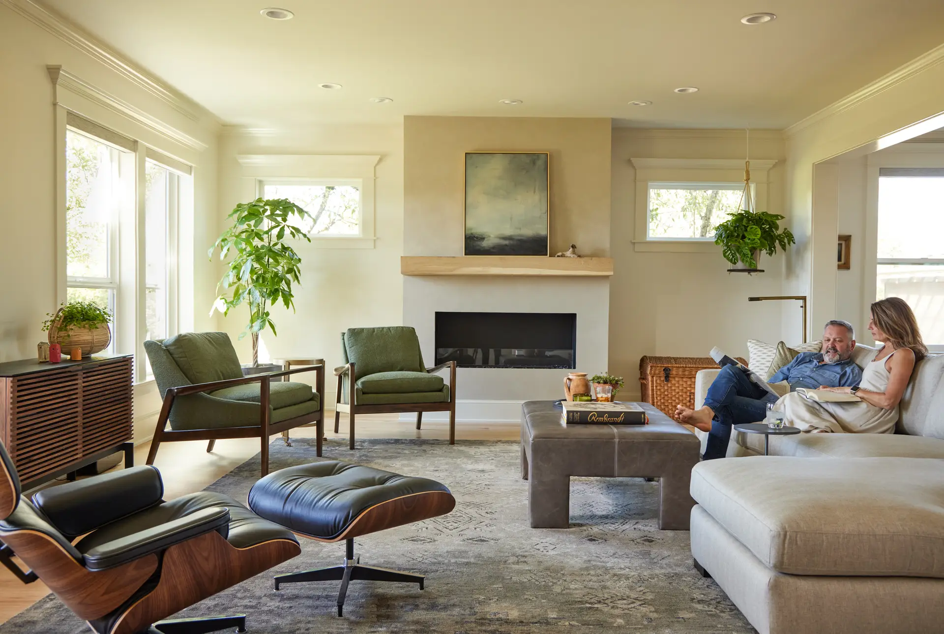 St. Paul Residence living room, featuring bright and warm walls, several furniture items, and a fireplace in the background.