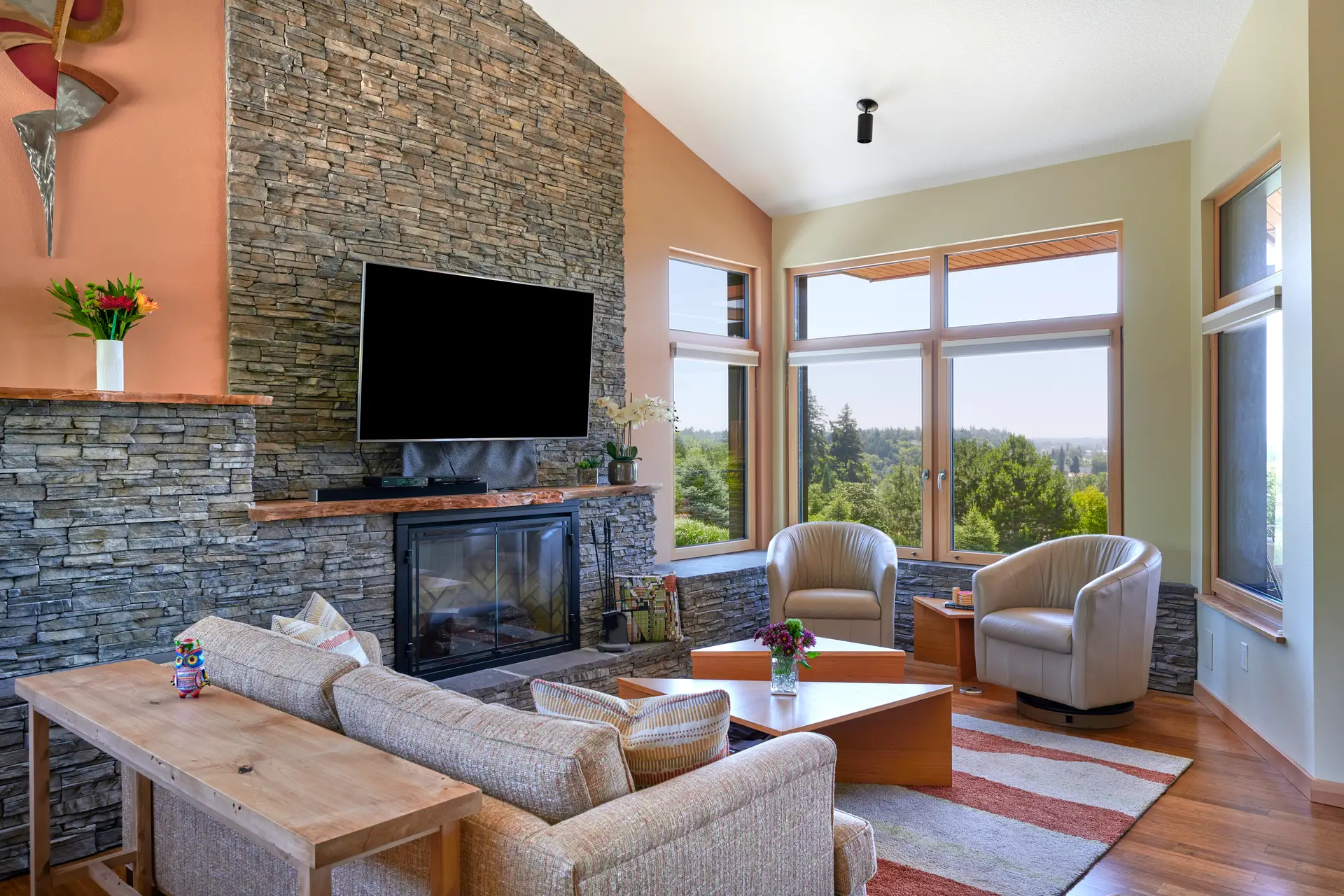 Vancouver Residence firepace and living room, featuring highly textured stone fireplace along with light green and peach walls.
