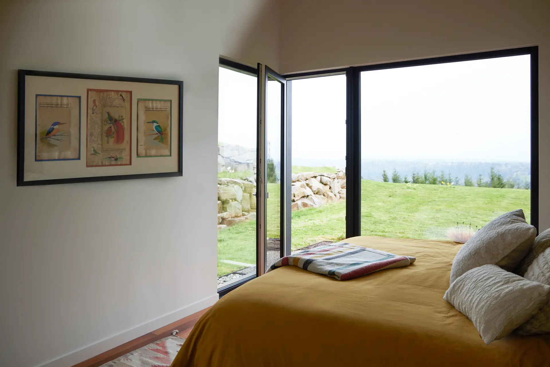 Corbett Residence bedroom overlooking the Sandy River. A glass door leads directly to the exterior.