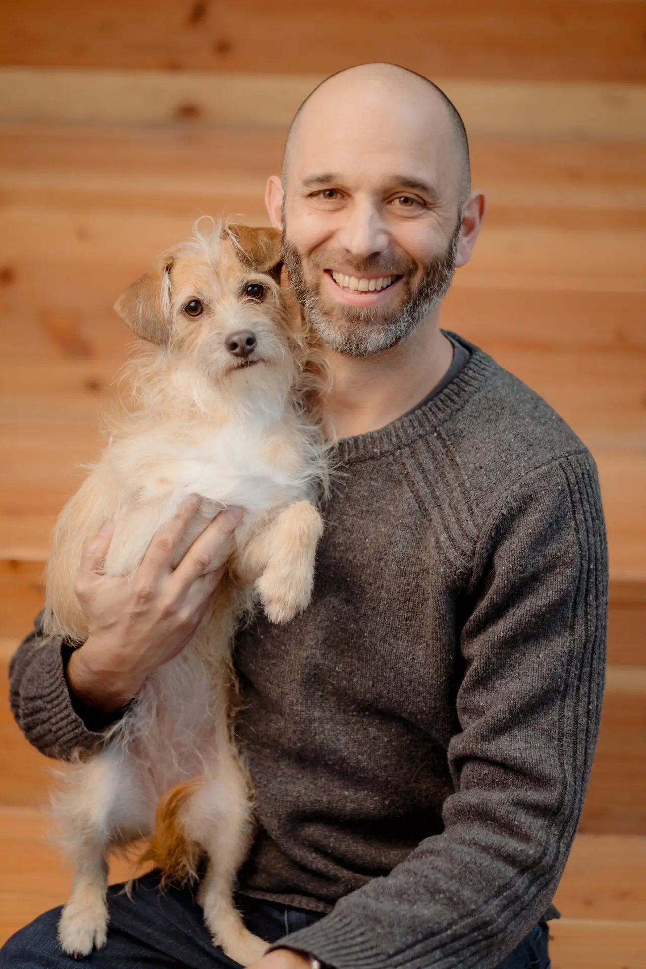 Stephen Aiguier holding his dog.
