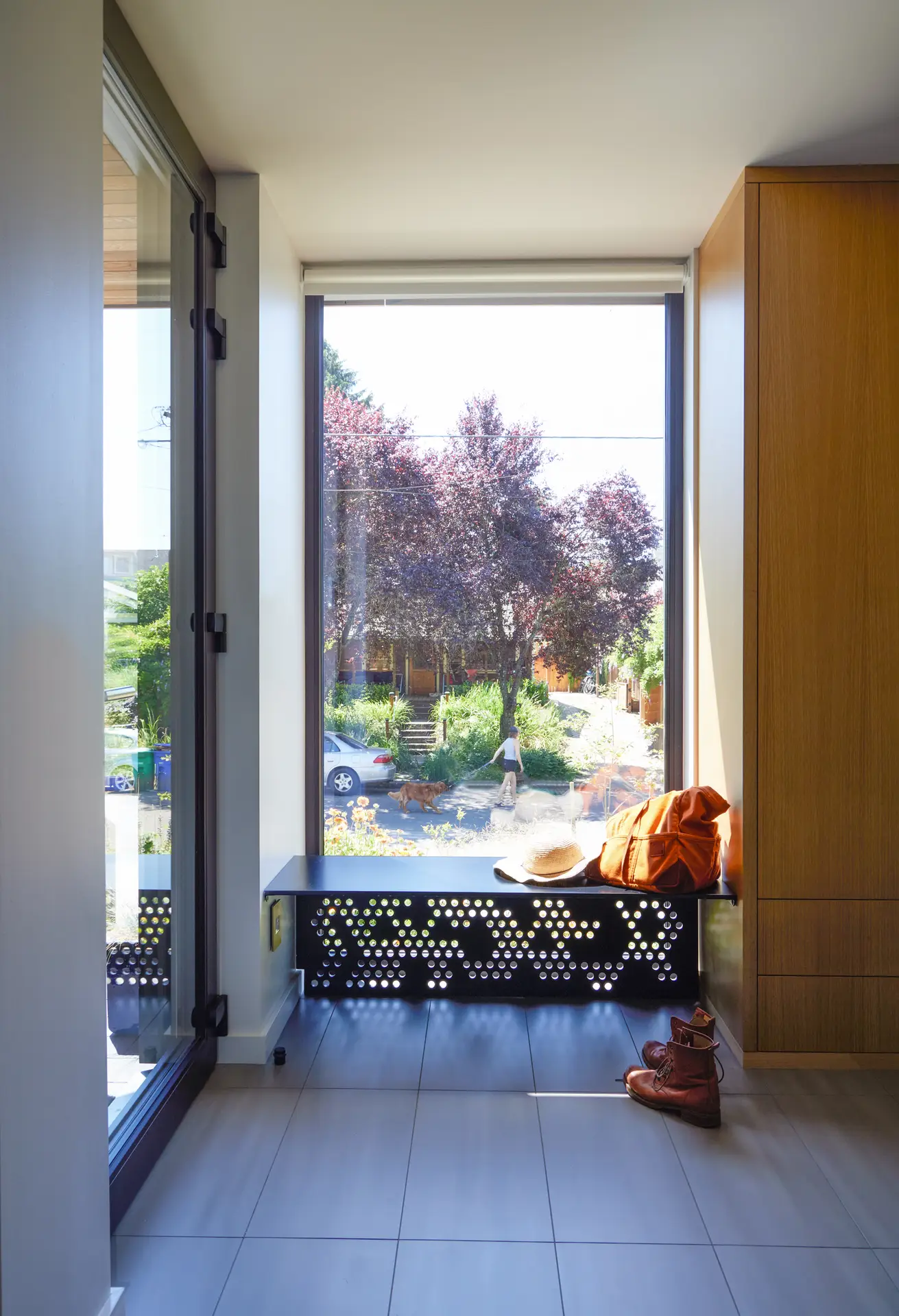 a large window and built in bench for removing shoes