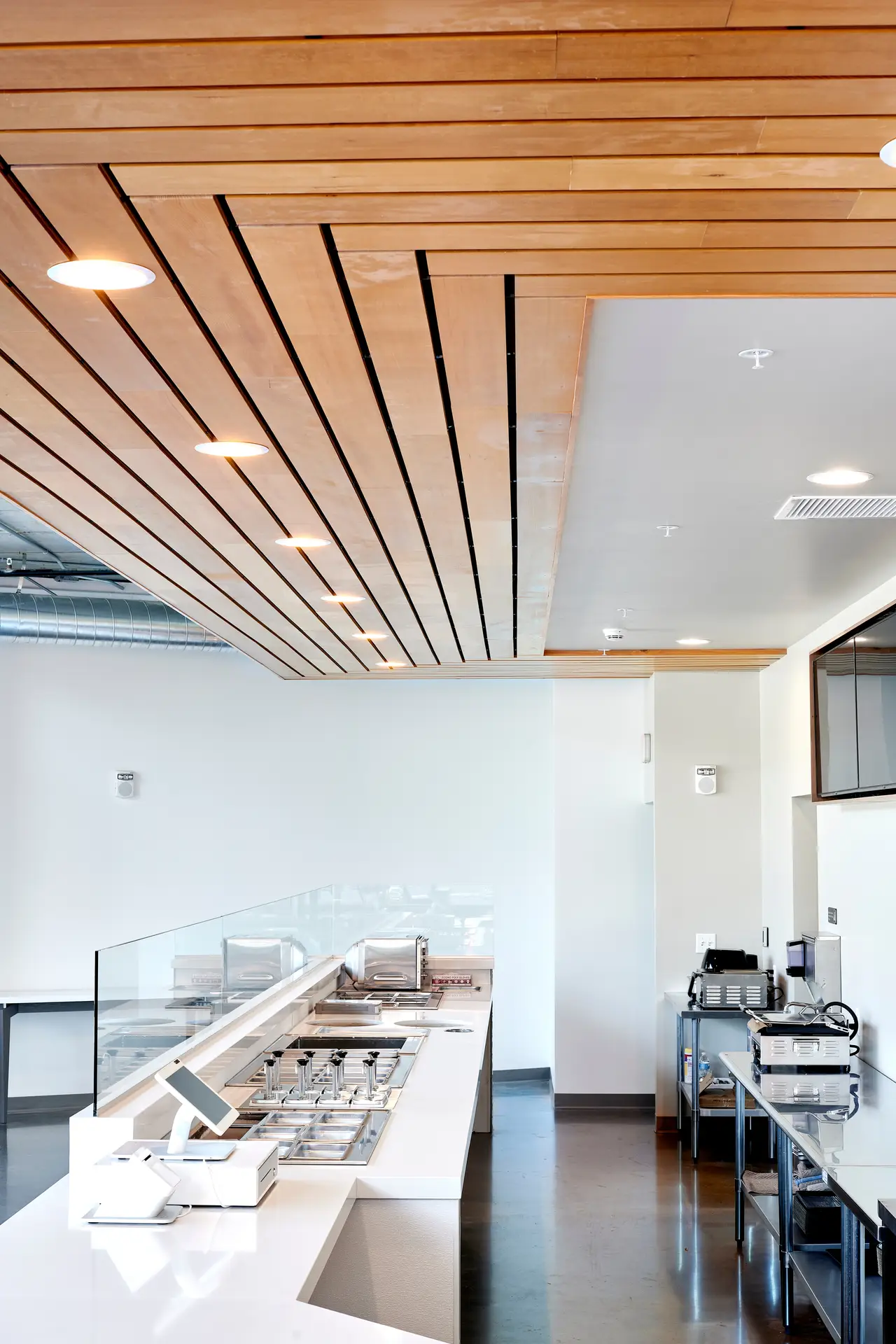 Intricate wood paneling on the ceiling over the counter at Olia Poke