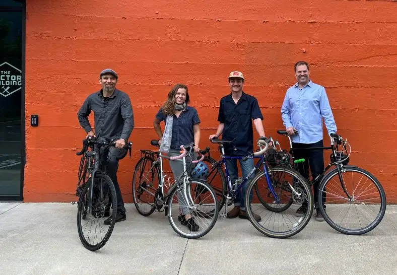Four Green Hammer team members biking to work.