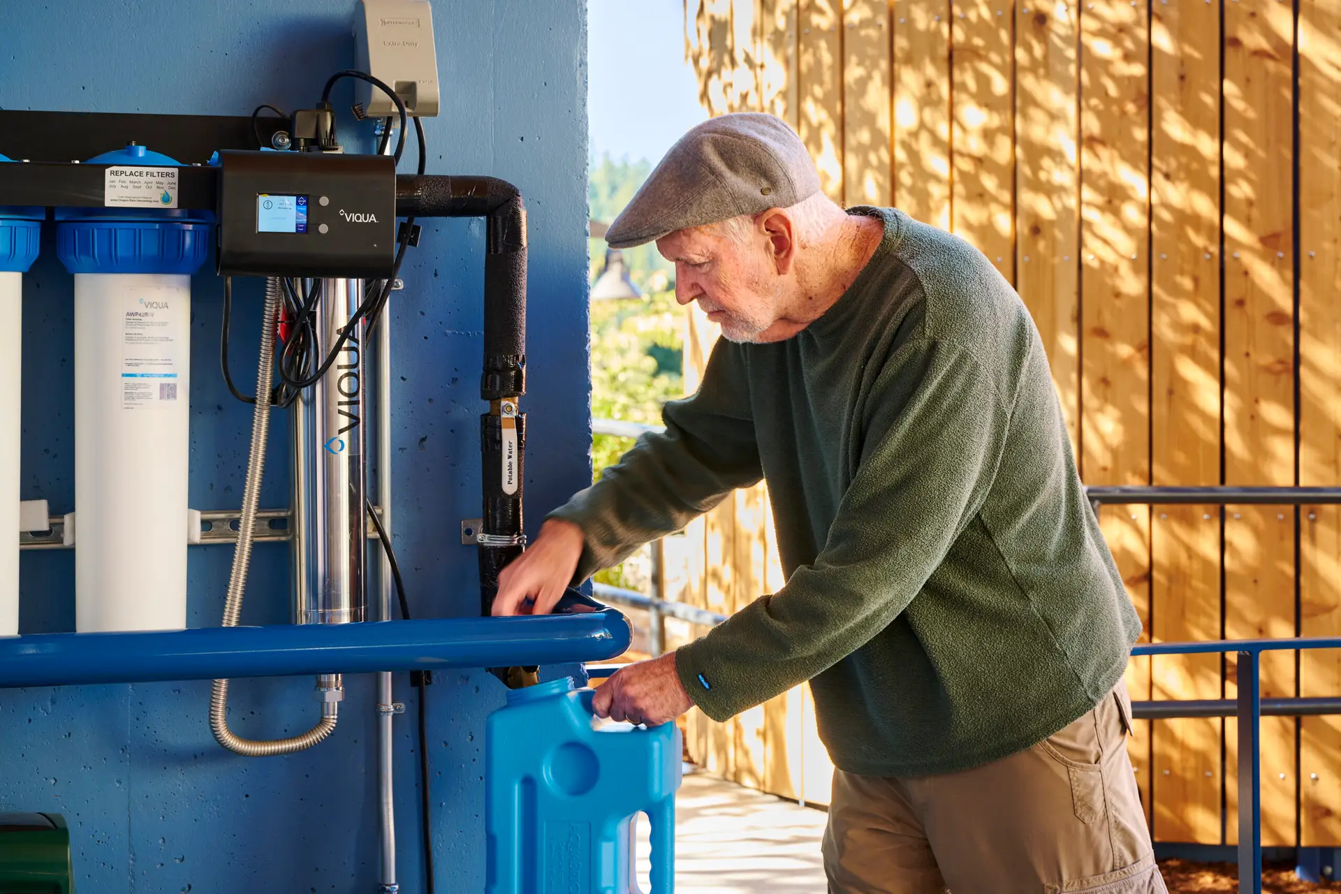 A resident using the water filtration system at ROSE Port
