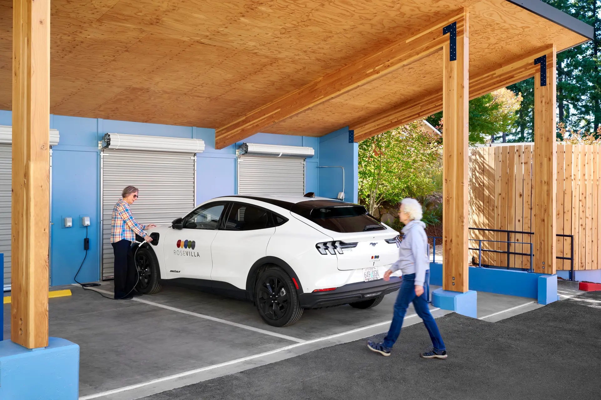 A resident using the car charger at ROSE Port