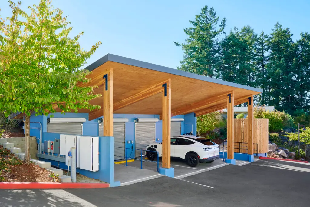 A view of the ROSE Port from the road, showing the mass plywood roof panels, glulam posts, battery storage and rollup doors for storage.