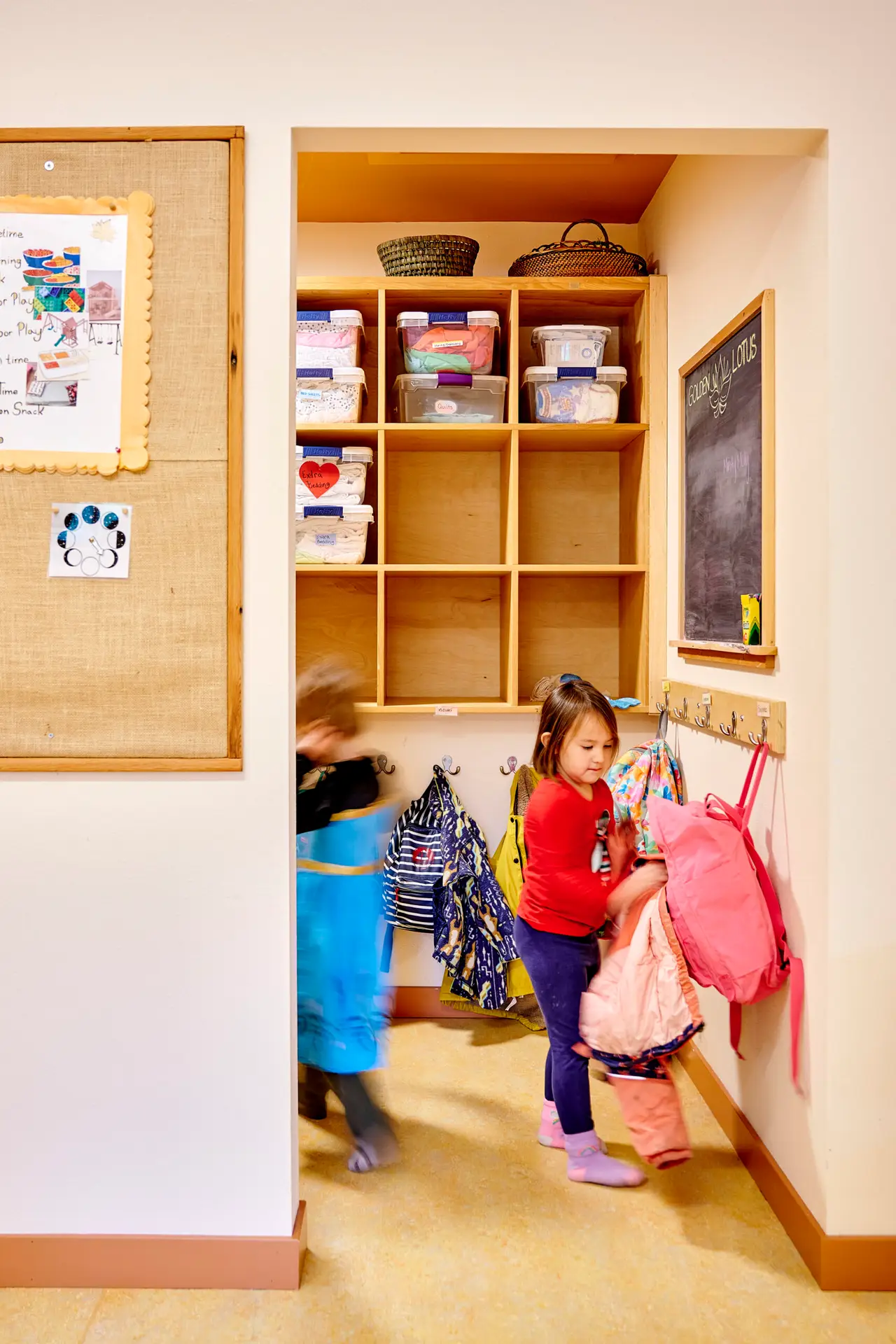 Children using the cubbies to store their things.
